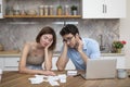 Family financial crisis concept. Shocked and stressed couple counting expenses, taxes and debts Royalty Free Stock Photo