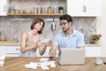 Family financial crisis concept. Shocked and stressed couple counting expenses, taxes and debts Royalty Free Stock Photo