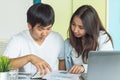 Happy asian couple discussing about documents for insurance plan investment Royalty Free Stock Photo