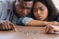 Family Financial Problems. Black Couple Counting Remaining Coins, Suffering From Poverty