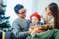 Family finds digital tablet in gift on Christmas night, near the wood stove Royalty Free Stock Photo