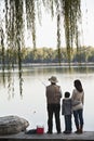 Family fishing off a dock at lake