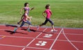 Family fitness, mother and kids running on stadium track, training and children sport healthy lifestyle