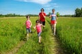 Family fitness outdoors, parents with kids jogging in park, running together Royalty Free Stock Photo