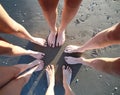 Family of five barefoot people in circle on the sandy sea beach Royalty Free Stock Photo