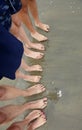 Family of five barefoot people on the sand in line on the sandy Royalty Free Stock Photo