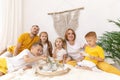 Family of five and their cat having breakfast in their bed in the morning Royalty Free Stock Photo