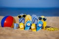 Family flip-flops, beach ball and snorkel on the sand. Summer vacation concept Royalty Free Stock Photo