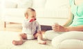 Mother and baby with spoon eating puree at home Royalty Free Stock Photo