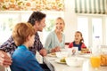 Family, food and parents with children for breakfast, eating and bonding together in dining room. Smile, happy mother Royalty Free Stock Photo