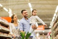 Family with food in shopping cart at grocery store Royalty Free Stock Photo