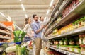 Family with food in shopping cart at grocery store Royalty Free Stock Photo