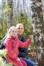 Family in the forest collecting birch sap