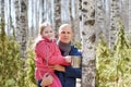 Family in the forest collecting birch sap