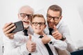 Father son and grandfather wearing formal clothing and glasses taking a selfie Royalty Free Stock Photo