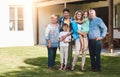 Family is the foundation of a home. Portrait of three generations of family standing together in the backyard. Royalty Free Stock Photo