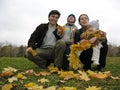 Family of four with autumn leaves Royalty Free Stock Photo