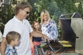 Family of four barbecuing