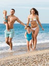 Family of four at the beach Royalty Free Stock Photo