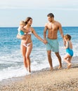 Family of four at the beach Royalty Free Stock Photo
