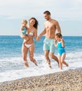 Family of four at the beach Royalty Free Stock Photo