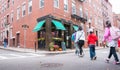 Family of four blurred in motion crossing street to cafe in Boston`s historic Little Italy district