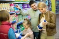 Family of four buying pasteurized milk together Royalty Free Stock Photo