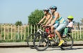 Family of four cycling on street Royalty Free Stock Photo