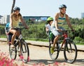 Family of four cycling on street Royalty Free Stock Photo