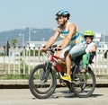 Family of four cycling on street Royalty Free Stock Photo