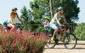 Family of four cycling on street Royalty Free Stock Photo