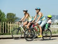 Family of four cycling on street Royalty Free Stock Photo