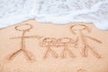 Family of four drawing on the beach