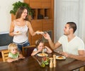 Family of four eating spaghetti