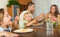 Family of four having lunch with pasta