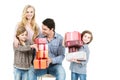 Family of four holding boxes with gifts.