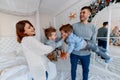 A family of four hugging in front of the christmas tree. love, happiness and big family concept Royalty Free Stock Photo