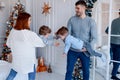 A family of four hugging in front of the christmas tree. love, happiness and big family concept Royalty Free Stock Photo