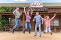 family of four jumping on background of wild west Royalty Free Stock Photo