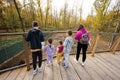 Family with four kids looking at wild animals from wooden bridge Royalty Free Stock Photo