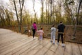 Family with four kids looking at wild animals from wooden bridge Royalty Free Stock Photo