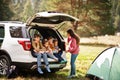 Family of four kids and mother at vehicle interior. Children sitting in trunk. Traveling by car in the mountains, atmosphere Royalty Free Stock Photo