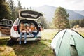 Family of four kids at vehicle interior. Children sitting in trunk. Traveling by car in the mountains, atmosphere concept Royalty Free Stock Photo