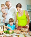 Family of four making delicious dumplings stuffed with fish