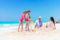 Family of four making sand castle on their beach vacation Royalty Free Stock Photo