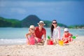 Family of four making sand castle at tropical white beach Royalty Free Stock Photo