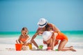 Family of four making sand castle at tropical white beach Royalty Free Stock Photo