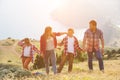 Family of four people looking to beautiful seascape in mountains