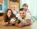 Family of four playing with kitten Royalty Free Stock Photo