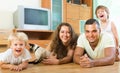 Family of four playing with kitten Royalty Free Stock Photo